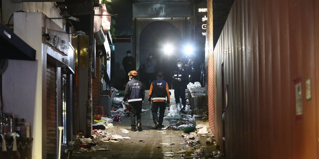 Emergency services at the scene of a deadly stampede during a Halloween festival on October 30, 2022 in Seoul's Itaewon district, after huge crowds of people gathered for Halloween parties, according to fire authorities. (Chung Sung-Jun/Getty Images)