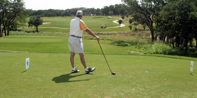 A golfer stands in the tee box at the Avery Ranch Golf Club in Austin, Texas. 