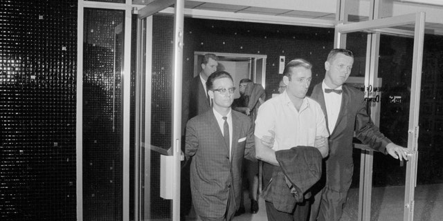 FBI agents escort Jack Murphy in connection with the theft of the Star of India and other jewels from the Museum of Natural History in New York.