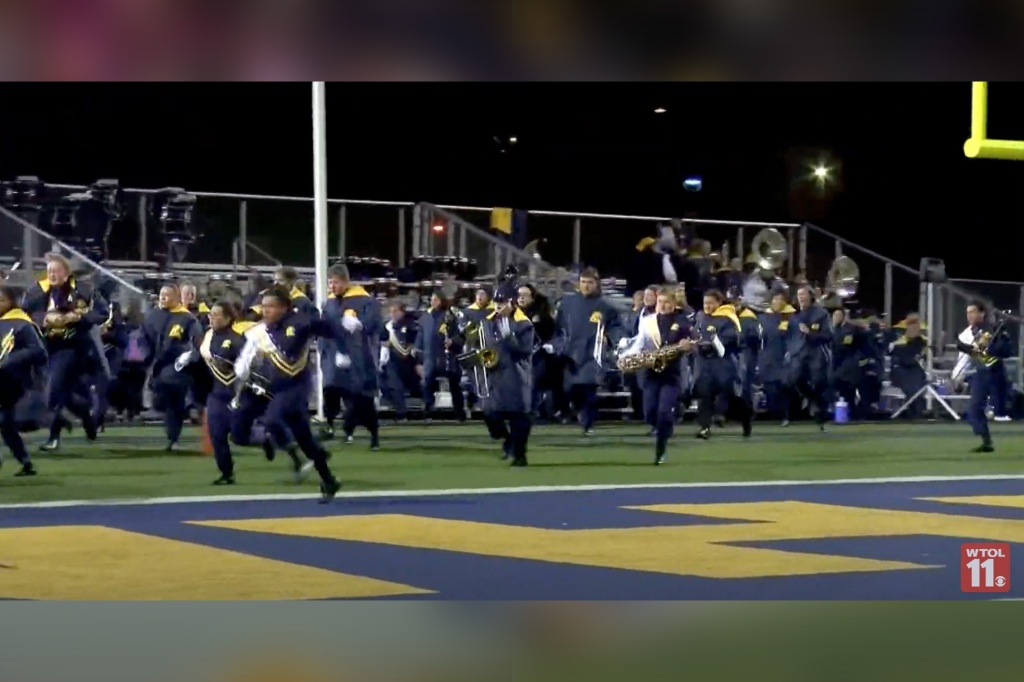 The schools marching band took off running, as did most of the fans, as shots rang out. 