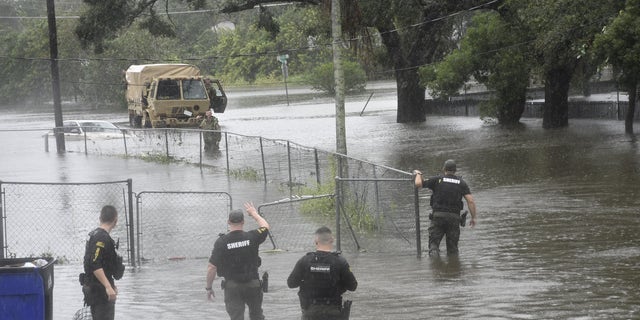 First responders from Orange County Sheriff's Office survey hurricane damage.