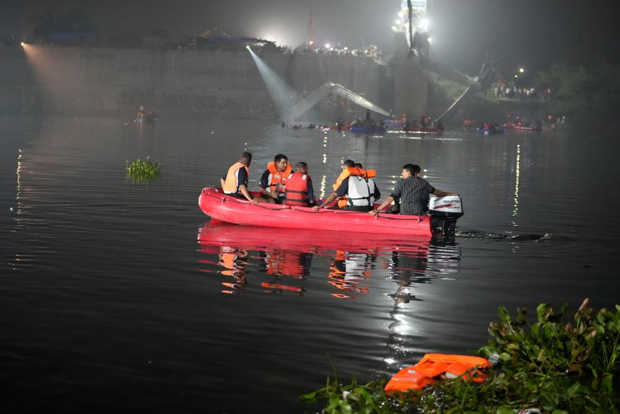 Rescuers on boats search in the Machchu river next to the cable bridge that collapsed in Morbi town of western state Gujarat, India on Oct. 31, 2022.