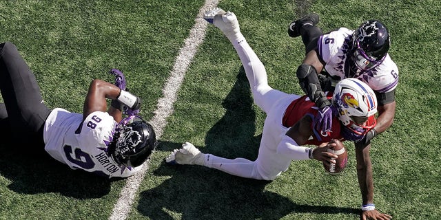 Kansas quarterback Jalon Daniels is sacked by TCU linebacker Jamoi Hodge (6) during the first half on Oct. 8, 2022, in Lawrence, Kansas.