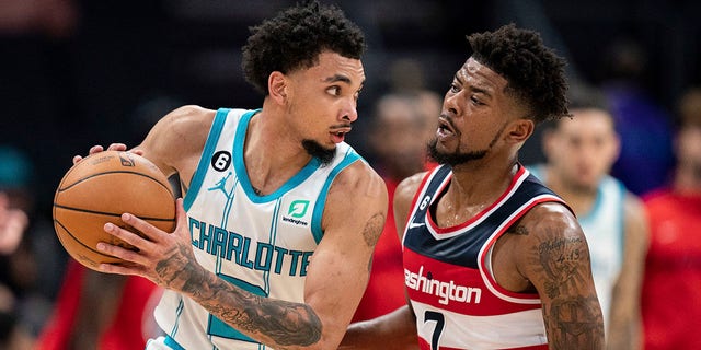 Washington Wizards guard Jordan Goodwin (7) guards Charlotte Hornets guard James Bouknight in the second half of an NBA preseason basketball game in Charlotte, N.C., Monday, Oct. 10, 2022. 