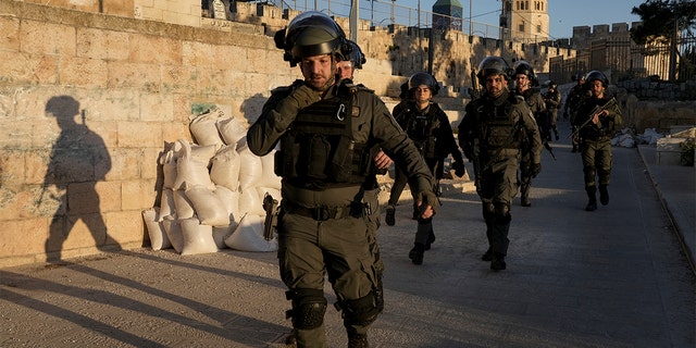 Israeli security forces gather during clashes with Palestinian demonstrators at the Al Aqsa Mosque compound in Jerusalem's Old City Friday, April 15, 2022. (AP Photo/Mahmoud Illean)