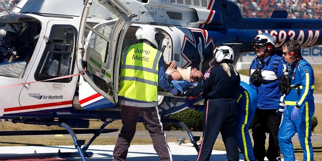 Driver Jordan Anderson is loaded into a helicopter after a fiery crash during the NASCAR Trucks Chevrolet Silverado 250 auto race, Saturday, Oct. 1, 2022, in Talladega, Alabama. 