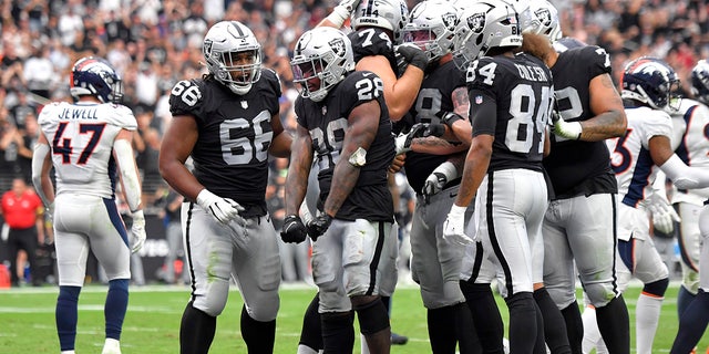 Las Vegas Raiders running back Josh Jacobs (28) celebrates his touchdown run against the Denver Broncos during the first half of an NFL football game, Sunday, Oct. 2, 2022, in Las Vegas. 