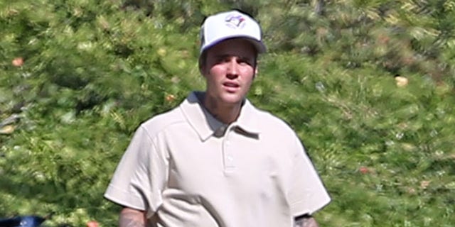 Justin Bieber walks the course.