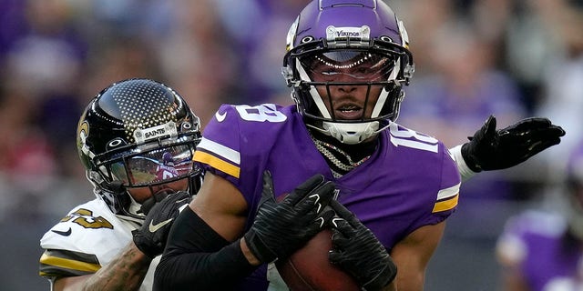 Minnesota Vikings wide receiver Justin Jefferson, #18, catches the ball ahead of New Orleans Saints cornerback Marshon Lattimore, #23, during the fourth quarter of an NFL match between Minnesota Vikings and New Orleans Saints at the Tottenham Hotspur stadium in London, Sunday, Oct. 2, 2022. 