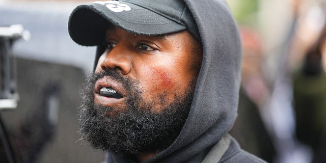 Kanye West wears a Balenciaga boxing mouthguard, outside Givenchy, during Paris Fashion Week on Oct. 2, 2022, in Paris, France.