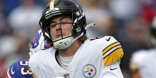 Pittsburgh Steelers quarterback Kenny Pickett is hit by Buffalo Bills linebacker Tyrel Dodson and Siran Neal after getting off a pass during the second half of a game in Orchard Park, N.Y., Sunday, Oct. 9, 2022.