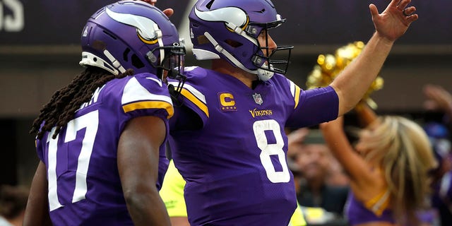 Minnesota Vikings quarterback Kirk Cousins (8) celebrates with teammate K.J. Osborn after scoring on a 17-yard touchdown run against the Arizona Cardinals, Oct. 30, 2022, in Minneapolis.