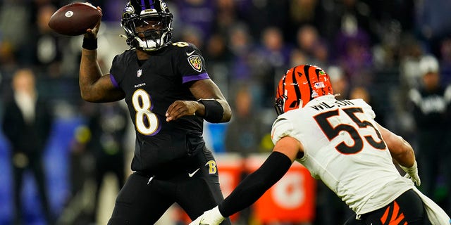 Baltimore Ravens quarterback Lamar Jackson passes the ball over Cincinnati Bengals' Logan Wilson during the second half of an NFL football game, Sunday, Oct. 9, 2022, in Baltimore. 