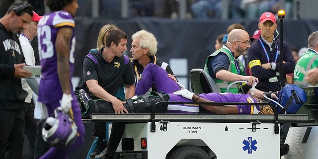 Minnesota Vikings safety Lewis Cine (6) is taken from the field after an injury during an NFL match between the Minnesota Vikings and New Orleans Saints at the Tottenham Hotspur stadium in London, Sunday, Oct. 2, 2022. 