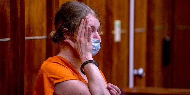 Courtney Clenney covers her face during an evidentiary hearing. She is the OnlyFans model accused of murdering her boyfriend Christian Obumseli last April in Miami. 