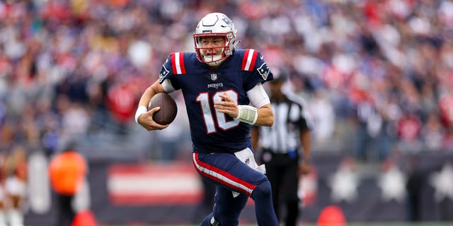 Quarterback Mac Jones of the New England Patriots runs the ball against the Baltimore Ravens at Gillette Stadium on Sept. 25, 2022, in Foxborough, Massachusetts.