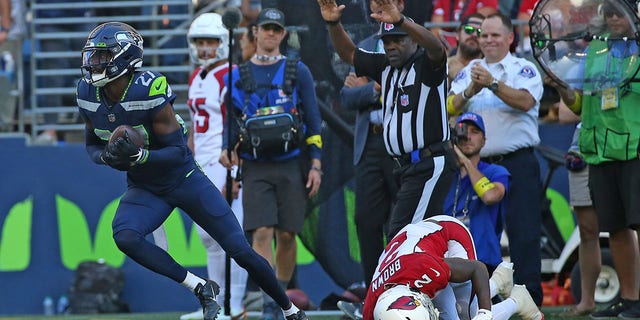 Tariq Woolen, #27 of the Seattle Seahawks, intercepts a pass intended for Marquise Brown, #2 of the Arizona Cardinals, during the fourth quarter at Lumen Field on Oct. 16, 2022 in Seattle.