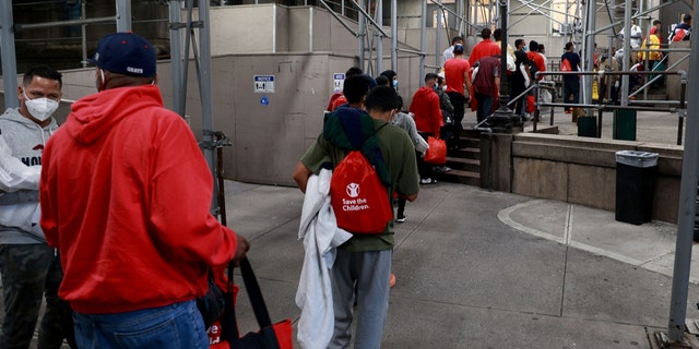 Around 60 recently arrived Venezuelan migrants are seen entering a shelter at Bellevue early Wednesday morning, Oct. 12, 2022, in Manhattan, New York. 