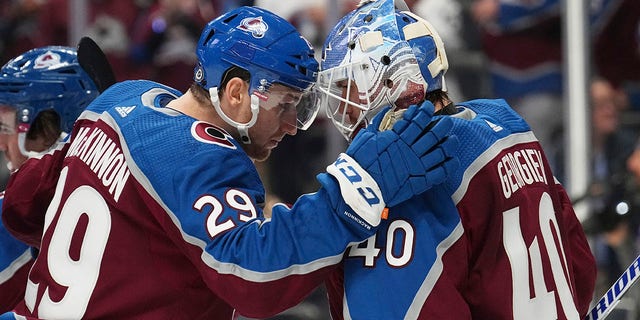 Colorado Avalanche center Nathan McKinnon congratulates goaltender Alexandar George after the team's 5-2 win against the Chicago Blackhawks, Wednesday, Oct. 12, 2022, in Denver.