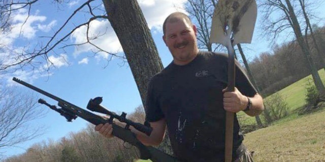 Nicholas Brutcher, shown holding a gun