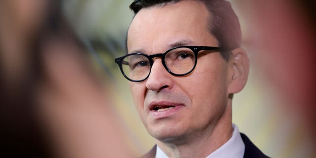 FILE - Poland's Prime Minister Mateusz Morawiecki speaks with the media as he arrives for an EU summit in Brussels on Oct. 21, 2022. Morawiecki said late Friday, Oct. 28, 2022 that Poland's nuclear energy project will use the "reliable, safe technology" of Westinghouse Electric Company, saying a strong Poland-U.S. alliance "guarantees the success of our joint initiatives." (AP Photo/Olivier Matthys, File)