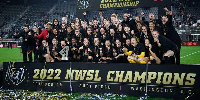 Portland Thorns pose with the trophy after they won the NWSL championship against the Kansas City Current, Saturday, Oct. 29, 2022.