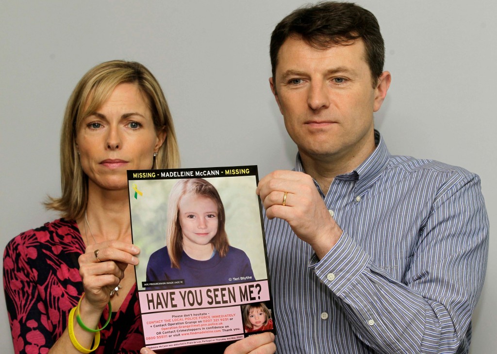Kate and Gerry McCann, Madeleine's parents, pose for the media with a missing poster of their child.