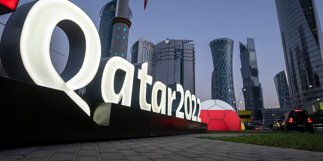 Branding is displayed near the Doha Exhibition and Convention Center where soccer World Cup draw will be held, in Doha, Qatar, Thursday, March 31, 2022. The final draw will be held on April 1.