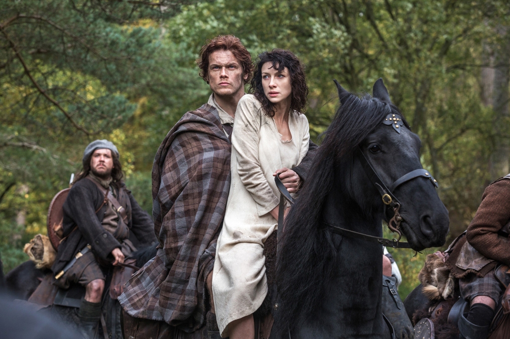 Caitriona Balfe as Claire Randall, right, and Sam Heughan as Jamie Fraser, center, and Grant O'Rourke as Rupert MacKenzie, in a scene from Starz' new TV series, "Outlander." (AP Photo/Sony Pictures Television, Ed Miller)