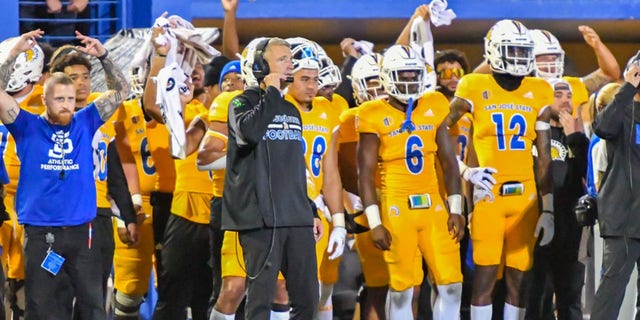 San Jose State Spartans head coach Brent Brennan talks to his staff on his headset during a game against the UNLV Rebels at CEFCU Stadium in San Jose, California, on Oct. 7, 2022.