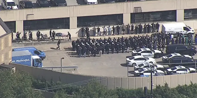 Dozens of officers lined up outside the hospital in Dallas to pay their respects to Arellano. 