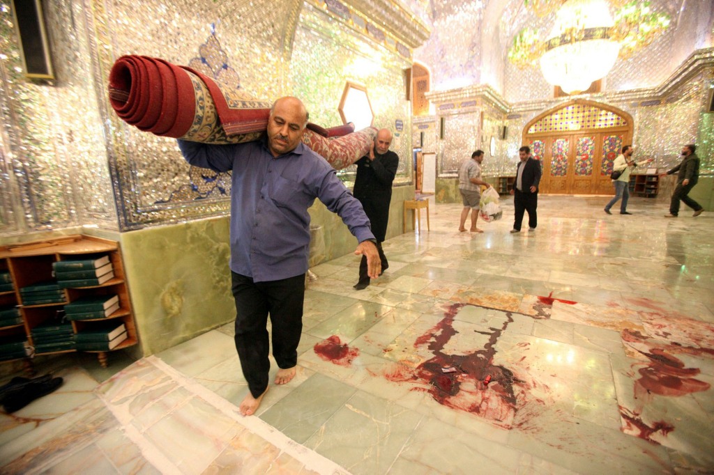 Workers clean up the scene following an armed attack at the Shah Cheragh mausoleum in the Iranian city of Shiraz on October 26, 2022.