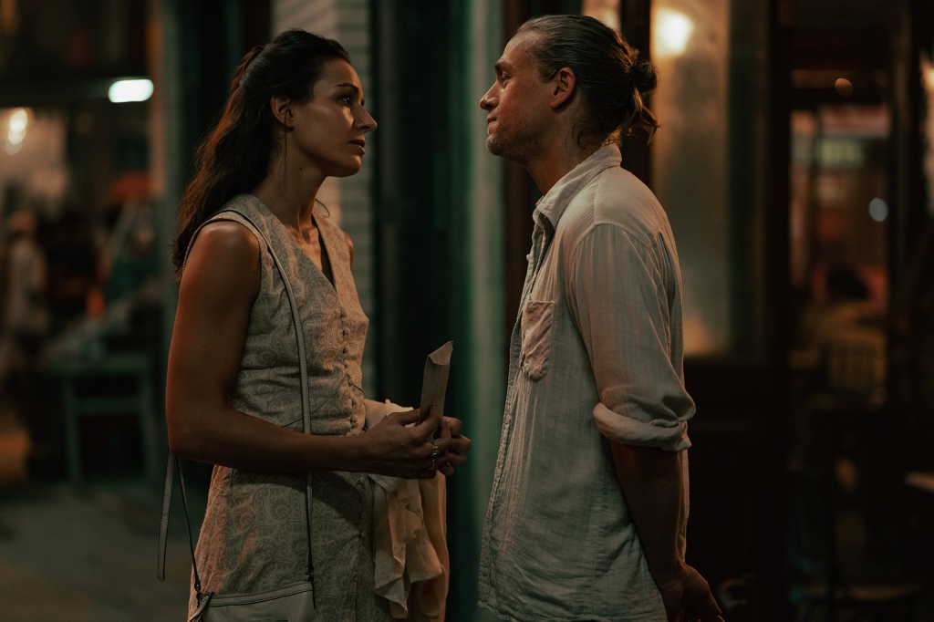 Antonia Desplat and Charlie Hunnam in "Shantaram" smiling at each other. 