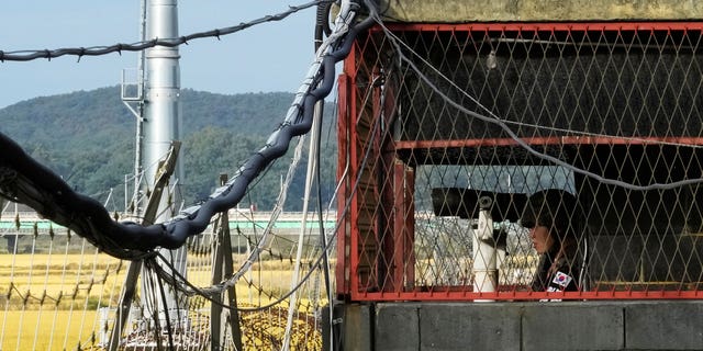 A South Korean army soldier stands guard inside a military guard post at the Imjingak Pavilion in Paju, South Korea, near the border with North Korea, Friday, Oct. 14, 2022.