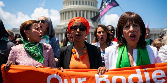 Rep. Nydia Velazquez, a Democrat from New York, left, Rep. Ilhan Omar, a Democrat from Minnesota, and Rep. Jackie Speier, a Democrat from California, march toward the U.S. Supreme Court during a protest of the court overturning Roe v. Wade in Washington on July 19, 2022.