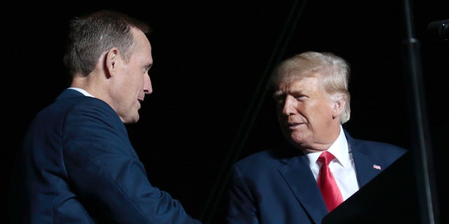 Former President Trump, right, headlined a rally for Rep. Ted Budd.