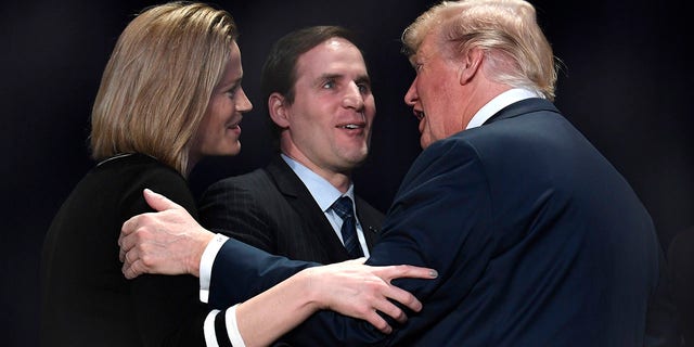 President Donald Trump greets US Army Maj. Scott Smiley (Ret.), who was blinded during the Iraq War, and his wife Tiffany at the National Prayer Breakfast on Feb. 8, 2018 in Washington, DC.