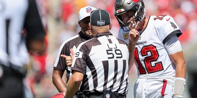 Line judge Rusty Baynes speaks with Tampa Bay Buccaneers quarterback Tom Brady during the Atlanta Falcons game, Sunday, Oct. 9, 2022, in Tampa.