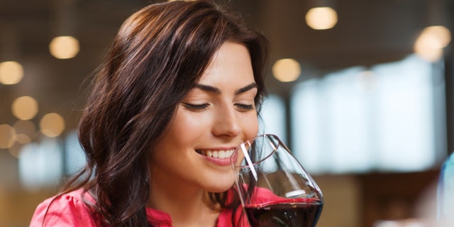 A woman drinking a glass of wine