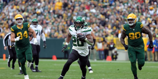 Breece Hall #20 of the New York Jets rushes for a touchdown in the fourth quarter of a game against the Green Bay Packers at Lambeau Field on October 16, 2022, in Green Bay, Wisconsin.