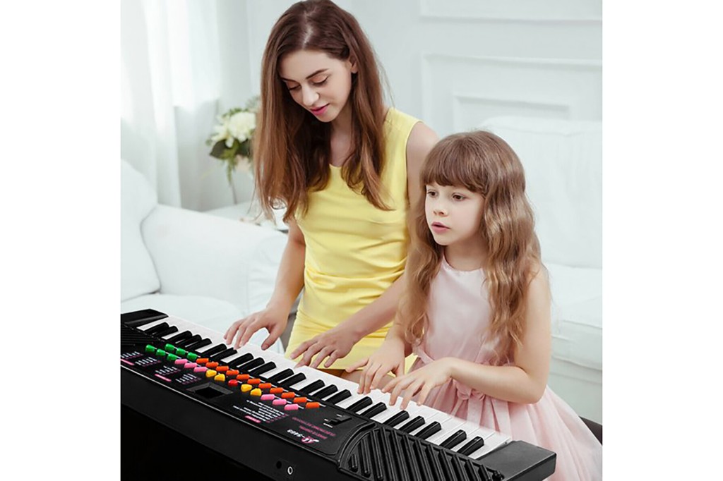 A woman and a little girl playing the keyboard 