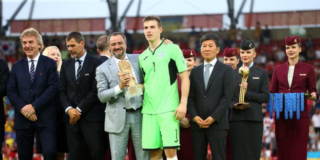 Andriy Pavelko, President of the Football Federation of Ukraine presents Andriy Lunin of Ukraine with the Golden Glove Award following the 2019 FIFA U-20 World Cup Final between Ukraine and Korea Republic at Lodz Stadium on June 15, 2019 in Lodz, Poland.