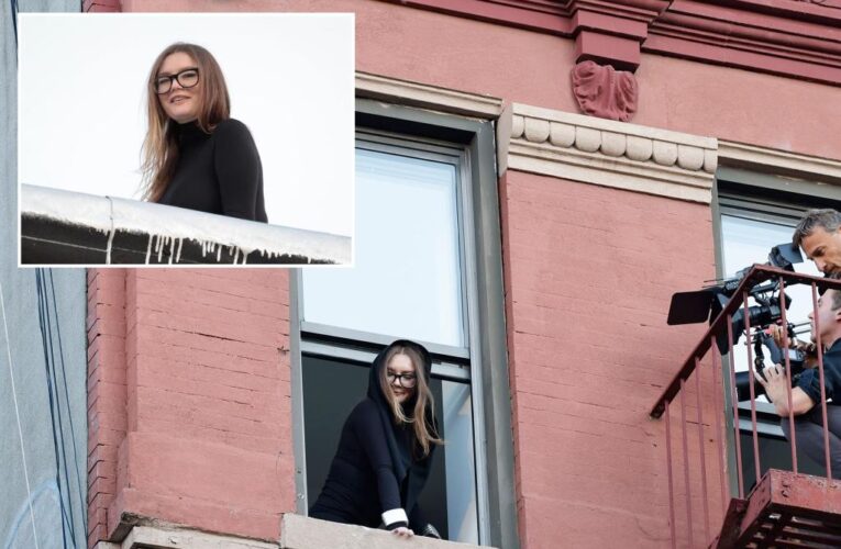 Anna Sorokin, out on house arrest, poses from window and roof of new Manhattan apartment