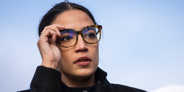 Rep. Alexandria Ocasio-Cortez, D-N.Y., prepares to speak during a rally for immigration provisions to be included in the Build Back Better Act outside the U.S. Capitol in Washington, D.C., on Dec. 7, 2021.