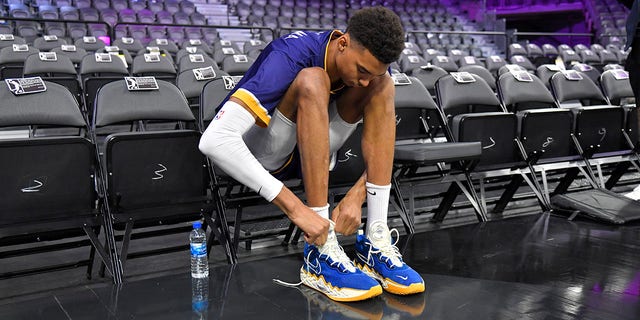 Victor Wembanyama of Metropolitans 92 ties his sneakers before a game against the G League Ignite Oct. 6, 2022, at The Dollar Loan Center in Henderson, Nev.