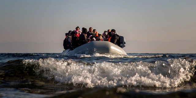 Refugees and migrants approach the Greek island of Lesbos on a dinghy after crossing the Aegean sea from the Turkish coast, on Monday, Dec. 7, 2015. Greece is the main point of entry into the EU for people fleeing war and poverty at home, with the vast majority of the 700,000 people who have entered the country this year reaching Greek islands from the nearby Turkish coast. 