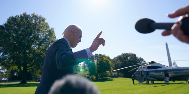 President Biden walks past reporters before boarding Marine One on the South Lawn of the White House Thursday, Oct. 20, 2022, in Washington.