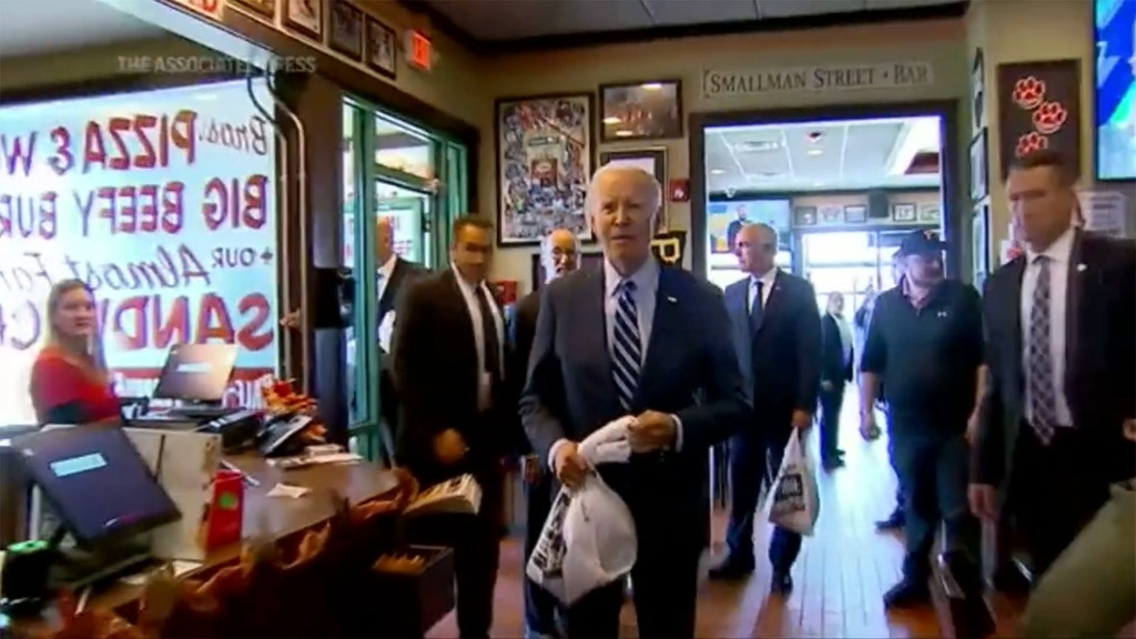 Biden walks toward reporter asking him questions Thursday in a sandwich shop stop.