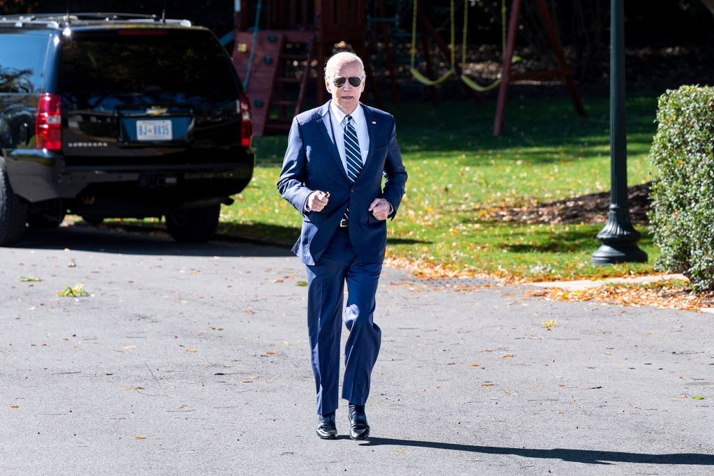 President Joe Biden jogs over to talk to the press before leaving the White House to start his trip to Syracuse, New York on Oct. 27, 2022.