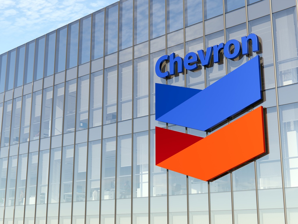 Chevron Corporation Signage Logo on Top of Glass Building. Workplace of Gas and Oil Company in High-rise Office Headquarters.